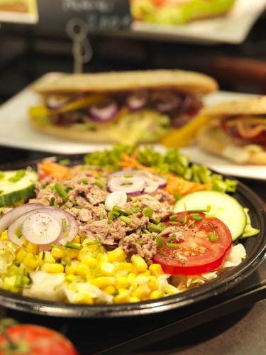 a plate of food with vegetables and a sandwich at Hotel Hansa in Herford