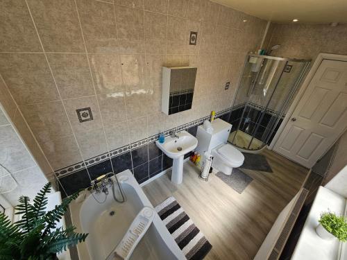 an overhead view of a bathroom with a tub and sink at Fantastic 4 Apartments in Dagenham Dock