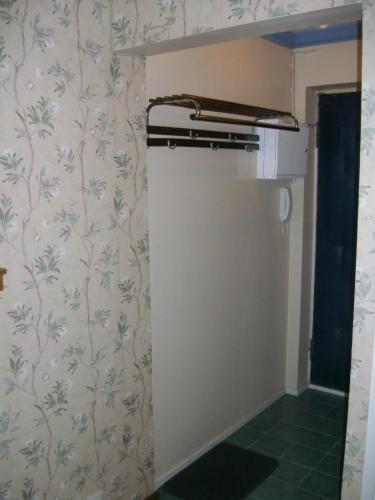 a kitchen with a wall with floral wallpaper at Patarei Apartment in Tallinn