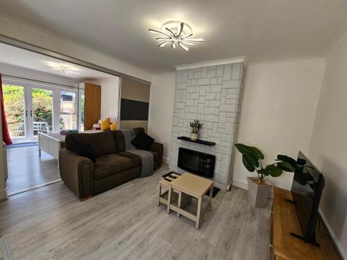 a living room with a couch and a fireplace at Fantastic 4 Apartments in Dagenham Dock