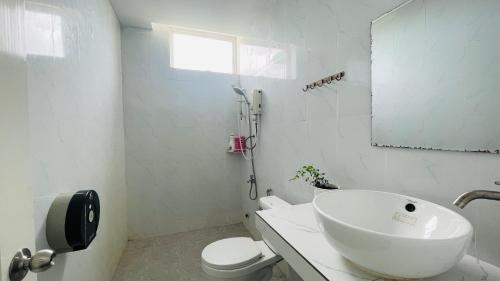 a bathroom with a sink and a toilet and a mirror at TATEK Villa in Kampot