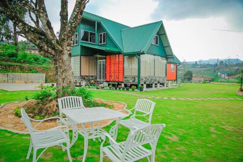 a table and chairs in front of a house at Mount Star Villa in Sita Eliya
