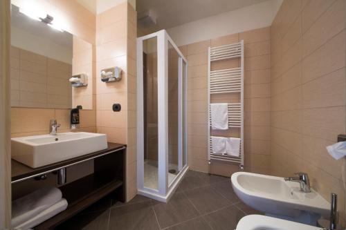 a bathroom with a sink and a mirror at Albergo Chalet Abete Rosso in Castello Tesino