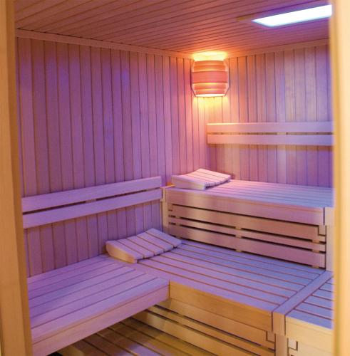 a purple sauna with two benches in it at Morada Hotel Isetal in Gifhorn