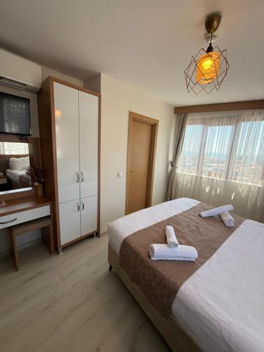 a bedroom with a bed with towels on it at Zeyn Otel Istanbul in Istanbul