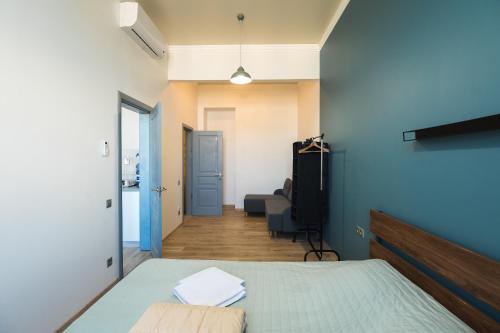 a bedroom with a bed and a hallway at Готельчик у Кірхи in Odesa