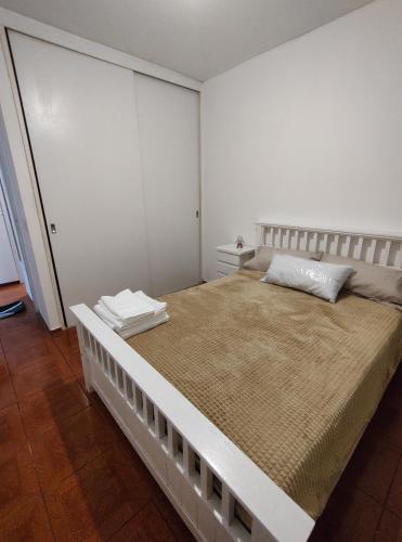 a white bedroom with a large bed in it at Vista sur in Buenos Aires