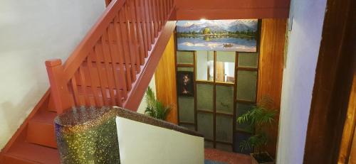 a stairway with a staircase with a painting on the wall at Hotel Shree Tara in Kathmandu