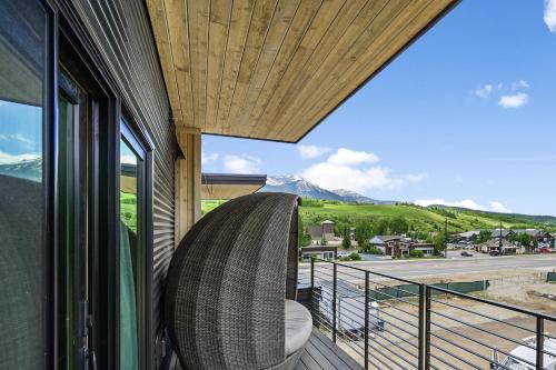 a room with a balcony with a view of a mountain at 4-Season Modern Mountain Penthouse with Private Hot Tub & Scenic Views in Silverthorne