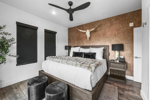 a bedroom with a large bed and a ceiling fan at 4-Season Modern Mountain Penthouse with Private Hot Tub & Scenic Views in Silverthorne