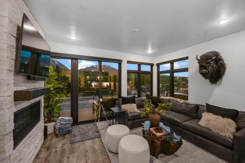a living room with a couch and a fireplace at 4-Season Modern Mountain Penthouse with Private Hot Tub & Scenic Views in Silverthorne