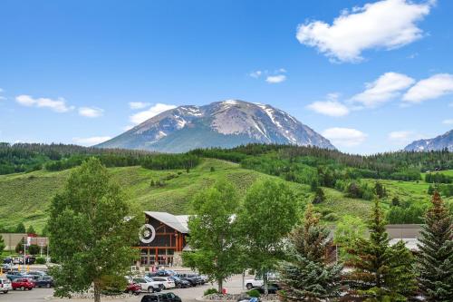 a mountain in the distance with a parking lot at 4-Season Modern Mountain Penthouse with Private Hot Tub & Scenic Views in Silverthorne
