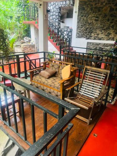 a balcony with chairs and a couch on it at MUM Jungle Inn in Ella
