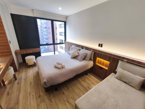 a bedroom with a bed with a stuffed animal on it at Republica del Salvador Coliving Ecuador XOE in Quito