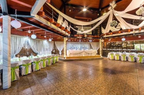 a banquet hall with white and green tables and chairs at Penzión NOVA in Spišská Stará Ves