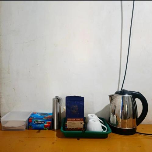 a shelf with a coffee maker and a tea kettle at Sendikala Lombok in Pancor