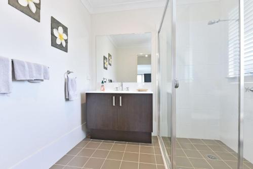 a bathroom with a shower and a sink at Seaspray Haven, 10 Seaspray Ave - air con, complex pool, Wi-Fi, Linen in Nelson Bay