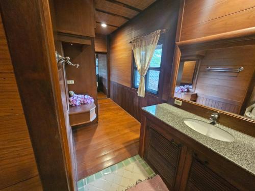 a bathroom with a sink and a mirror at Insda Wellness Resort in Chiang Mai