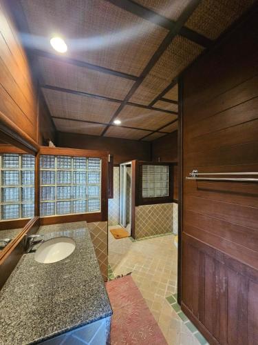 a bathroom with a sink and a shower at Insda Wellness Resort in Chiang Mai