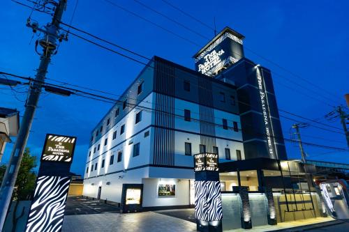 a building with a sign on the side of it at パサディナホテル11 市原店 in Ichihara