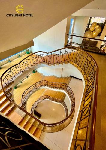 a spiral staircase in a building with aasteryasteryasteryasteryasteryasteryasteryastery at Citylight Hotel in Baguio