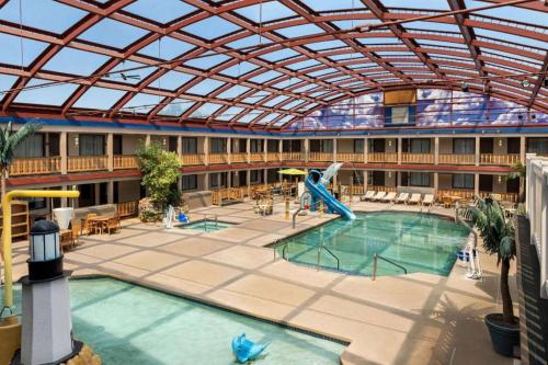 an indoor swimming pool with a slide in a building at AmericInn by Wyndham La Crosse Riverfront-Conference Center in La Crosse