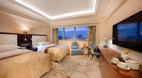 a hotel room with two beds and a large window at Jiaxing Sunshine Hotel in Jiaxing