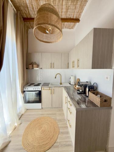 a kitchen with a sink and a stove at Villa Agora Nea Kalikratia in Nea Kalikratia