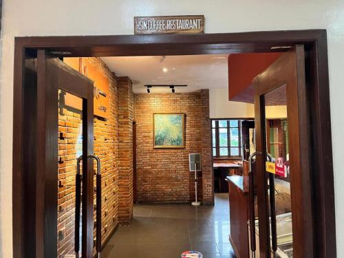 an entrance to a building with a brick wall at Mango Valley Hotel in Olongapo