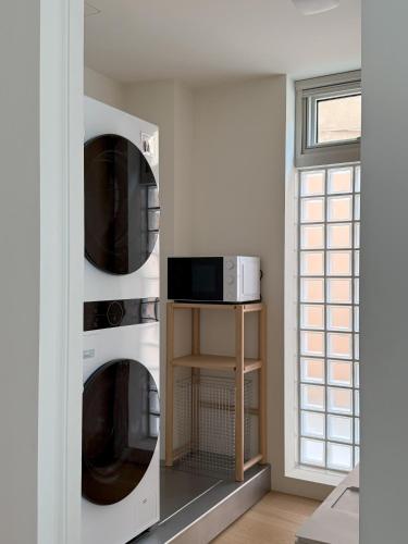 a kitchen with two microwaves in a wall at arrdep in Seoul