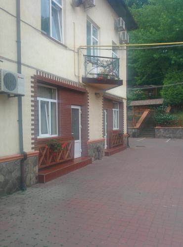 a building with a balcony on the side of it at Kaiser Hotel in Chernivtsi