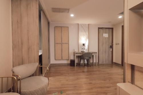 a living room with a desk and a table with chairs at Zigna Kampung Batik in Solo