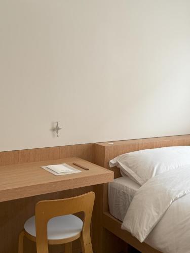 a bedroom with a desk with a bed and a chair at arrdep in Seoul