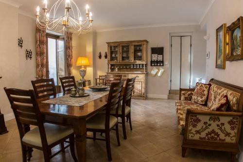a dining room with a table and chairs and a couch at Donna Chiara in Nusco