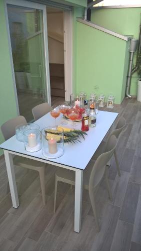 a white table with candles and food on it at Residence Diffuso Arcobaleno in Gabicce Mare