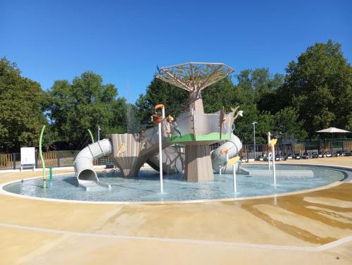 a playground with a water slide in a park at MOBIL HOME 6 Places - CLIMATISE in Aureilhan