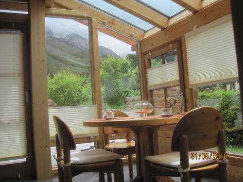 a room with a table and chairs and a large window at Haus der Sonne in Kötschach
