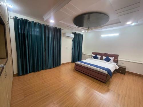 a bedroom with a bed and a tv in a room at Rawla in Jaipur
