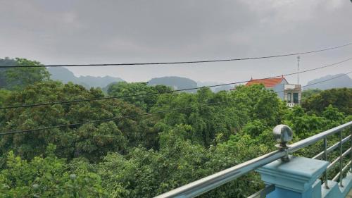 a balcony with a view of a forest of trees at Vi Hostel-Motels-Hotel in Vũ Lâm
