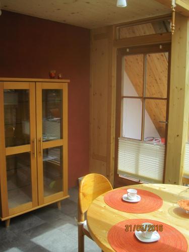 a dining room with a table and a cabinet at Haus der Sonne in Kötschach