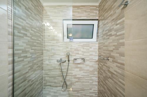 a bathroom with a shower with a window at Melograno in Markopoulo