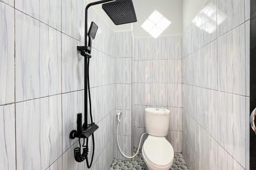 a bathroom with a shower with a toilet in it at SANS Stay New Favour Pagaralam in Bumiagung
