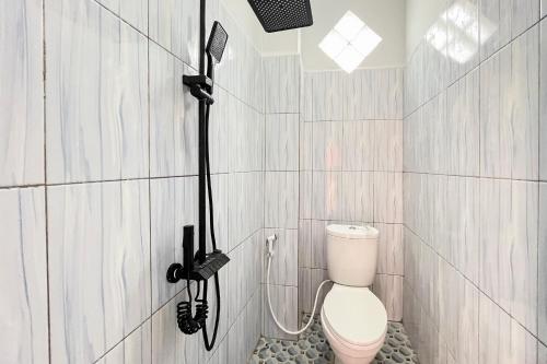 a bathroom with a shower with a toilet in it at SANS Stay New Favour Pagaralam in Bumiagung