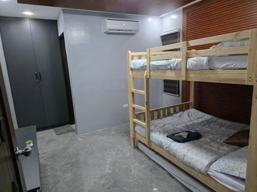 a room with two bunk beds and a door at Luxury Oasis Pool Villa in Sampong