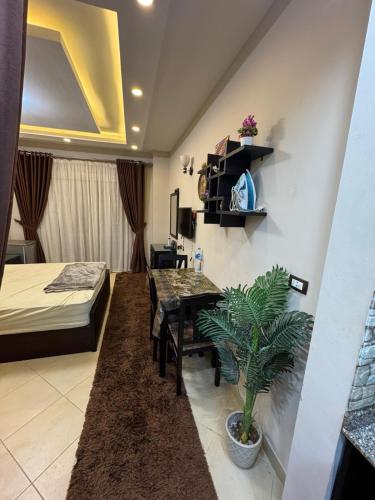 a room with a dining table and a bedroom at كمباوند فلورينزا 50 in Hurghada