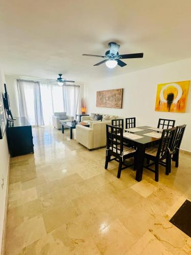 a living room with a table and chairs and a couch at La Esmeralda in Punta Cana