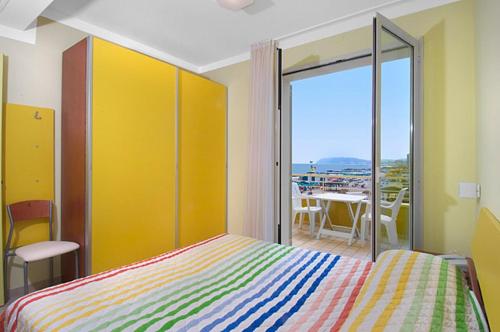 a bedroom with a bed and a view of the ocean at Residence Levante in Misano Adriatico