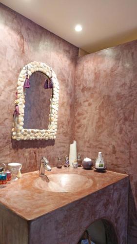 une salle de bain avec un lavabo et un miroir dans l'établissement Le Relais Du Grand Logis, à Civrieux