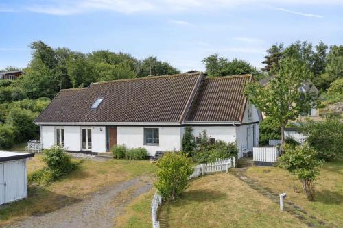 a white house with a brown roof at Holiday Bliss In Sandvig With Sea View in Sandvig