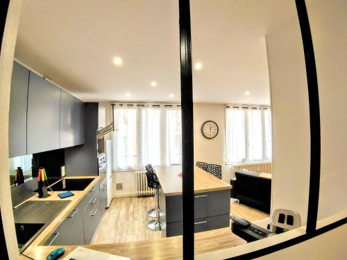 a kitchen with a counter and a large window at Une halte, Proche Notre-Dame in Rodez